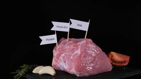 Hand labeling pork nutrients by black background Stock Footage 346278654