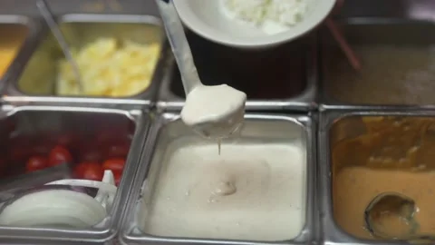 Hand ladles ranch dressing blue cheese at salad bar Stock-Footage 162012428