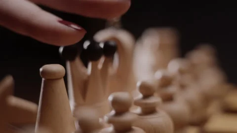 Hand of a lady making a move in chess game. Stock Footage 148436797