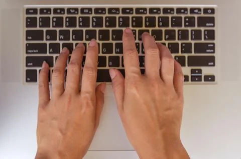 Hand on laptop. Stock Photos