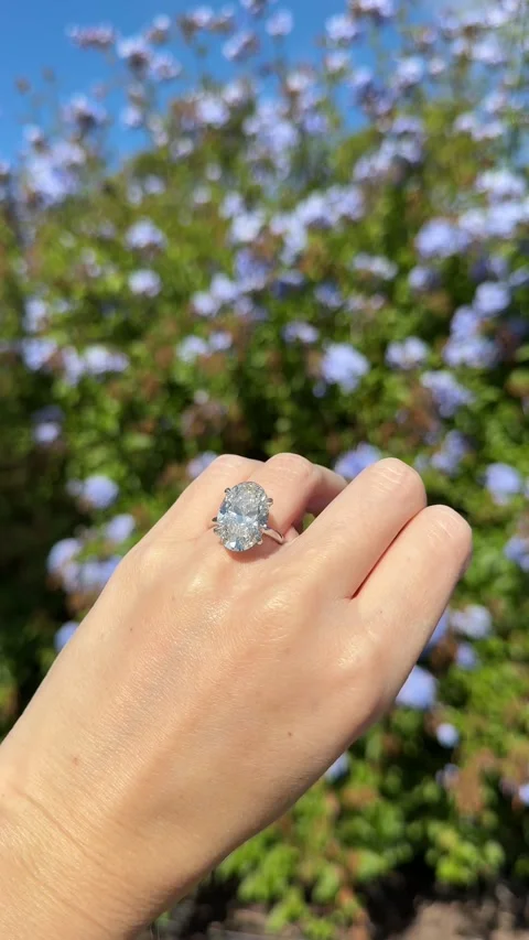 Hand with large oval diamond solitaire engagement ring with flowers Stock Footage 325821342