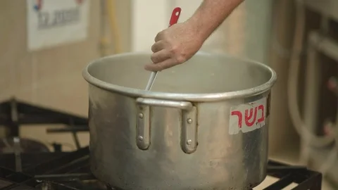 A hand with a large spoon stirring Meat stew Stock Footage 87868338