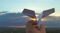 The hand launch paper airplane on stormy sunset background. slow motion capture 4k or 4k+ Resolution