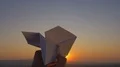 The hand launch paper airplane on sunset background. slow motion capture 4k or 4k+ Resolution