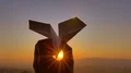 The hand launch paper airplane on sunset background. slow motion capture 4k or 4k+ Resolution