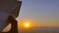 The hand launch paper airplane on sunset background. slow motion capture 4k or 4k+ Resolution