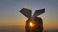 The hand launch paper airplane on sunset background. slow motion capture 4k or 4k+ Resolution