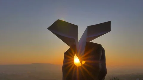 The hand launch paper airplane on sunset  background. slow motion capture Stock Footage 80634820