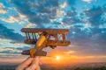 The hand launch toy plane on the background of a sunset Photo