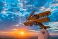 The hand launch toy plane on the background of a sunset Photo