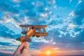 The hand launch toy plane on the background of a sunrise Photo