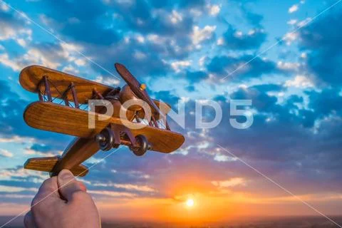 The hand launch toy plane on the background of a sunset Stock Photos