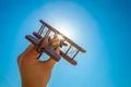The hand launch a wood plane on the background of the sun Photo