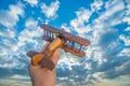 The hand launch wooden plane on the background of a blue sky Photo