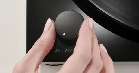 Hand launching the record by switching the control knob Stock Footage 155857378