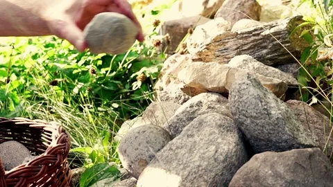 Hand laying down stone in the garden, 120fps Stock Footage 129919035