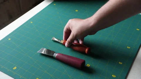 Hand lays out tools on the table to work with leather. Master tools for working 스톡 동영상 198496119