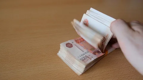 Hand leafing through a stack of Russia rouble bills Stock Footage 106196166