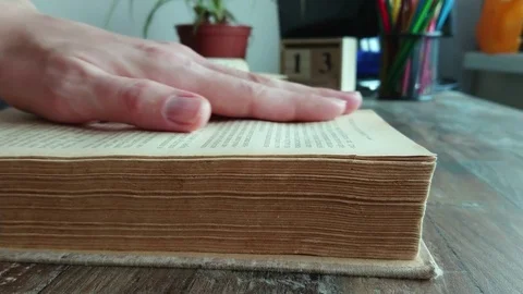 Hand leafs through pages of an old book, soft focus background Stock Footage 124827177