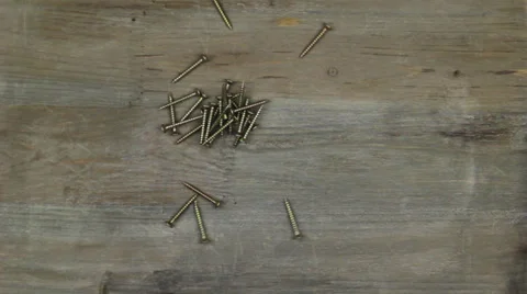 A hand leaves a mound of nails Stock Footage 24865920