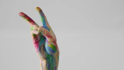 Hand of LGBT person painted with different colors shows victory or peace sign Stock Footage 158505585