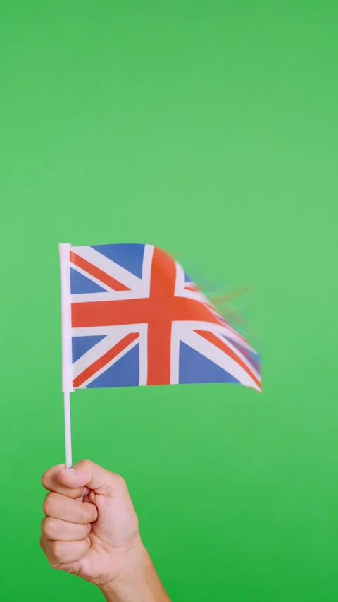 Hand lifting a british pennant while waving by the wind Stock Footage 254344730