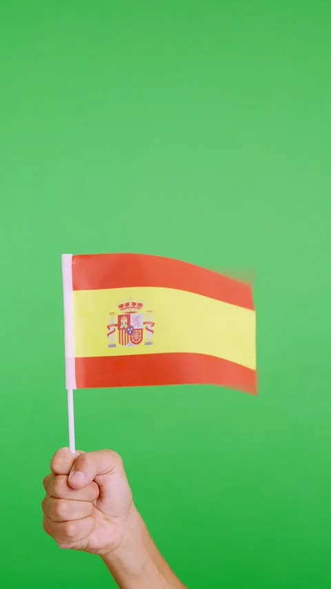 Hand lifting a spanish pennant while waving by the wind Vídeos de archivo 252057346
