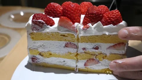 Hand Lifting a Tall Slice of Strawberry Layer Cake Stock Footage 340900852