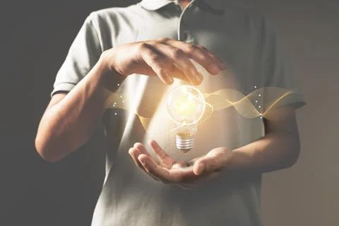 Hand with light bulb. idea concept with innovation and inspiration Stock Photos