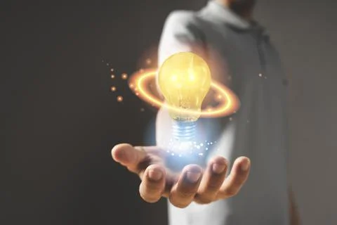 Hand with light bulb. idea concept with innovation and inspiration Stock Photos