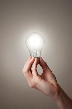 Hand with light bulb Stock Illustration