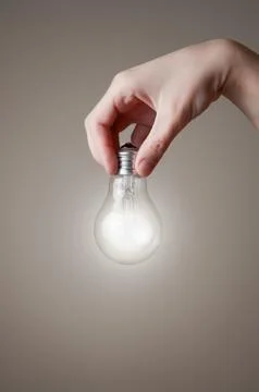 Hand with light bulb Stock Illustration