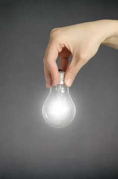 Hand with light bulb Stock Photos