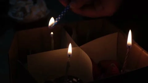 A hand light up candle with flame on a candle Stock Footage 227461919