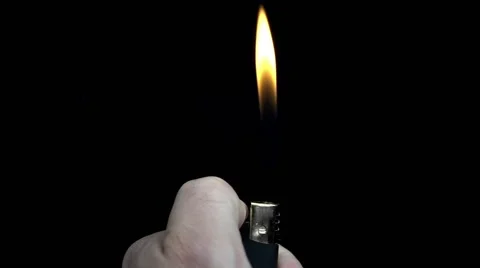 Hand light the lighter fire on black background Stock Footage 68068856