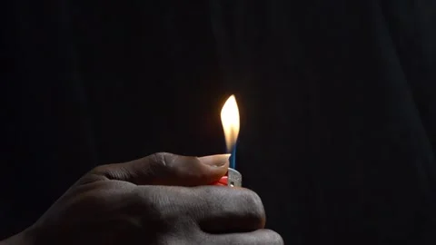 Hand with a lighter making fire Stock Footage 276594307