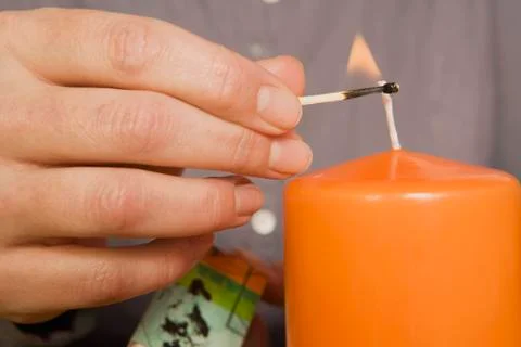 Hand Lighting Candle Stock Photos