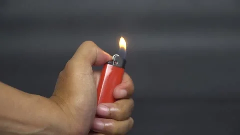 Hand Lighting a Gas Lighter with Small Flame Stock Footage 331515167