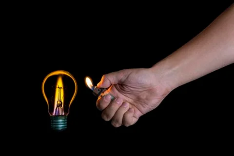 Hand lighting a lightbulb instead a candle Stock Photos