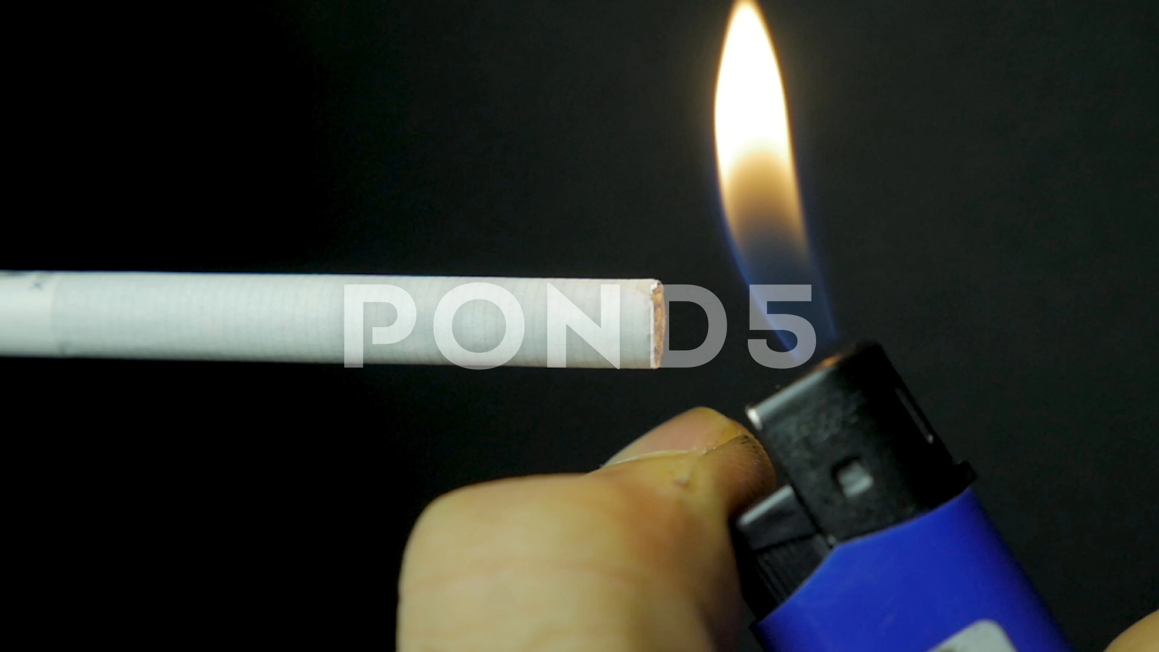 lighting a cigarette sound effect Hand lighting lighter cigarette closeup. Burning cigarette on black  background