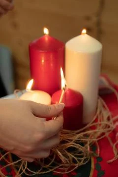 Hand lighting a set of colored candles Stock Photos