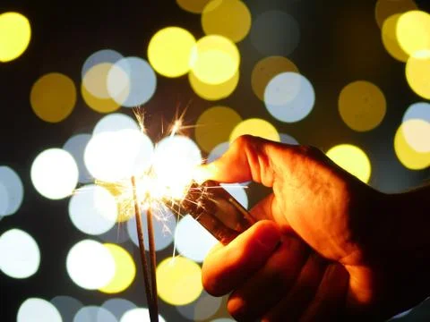 Hand lighting sparkler Stock Photos