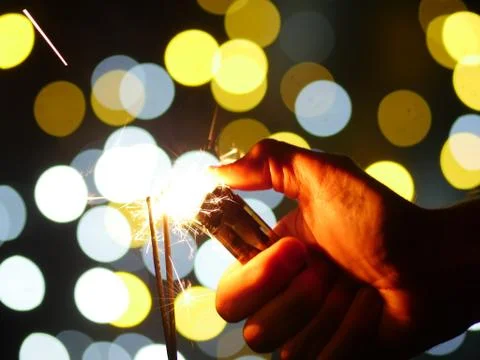 Hand lighting sparkler Stock Photos