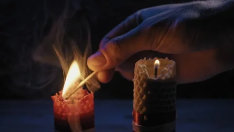 Hand Lighting Two Honeycomb Beeswax Candles With Match Stick In Dark Stock-Footage 329682034