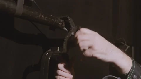 The hand of the lighting worker hangs a profile spotlight on the stand of the Stock Footage 309137936