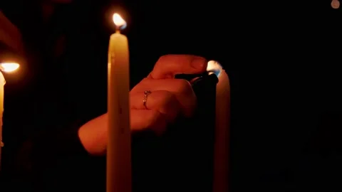 A hand lights a candle Stock Footage 152846454