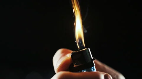 A hand lights a lighter up Stock Footage 156634341