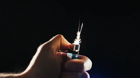 A hand lights a lighter up Stock Footage 156634495