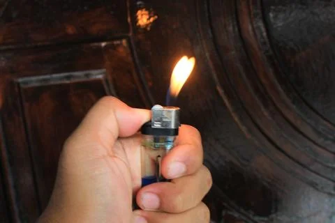 Hand lights a match Stock Photos