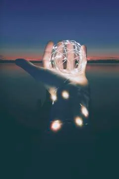 Hand with lights at the sunset Foto stock